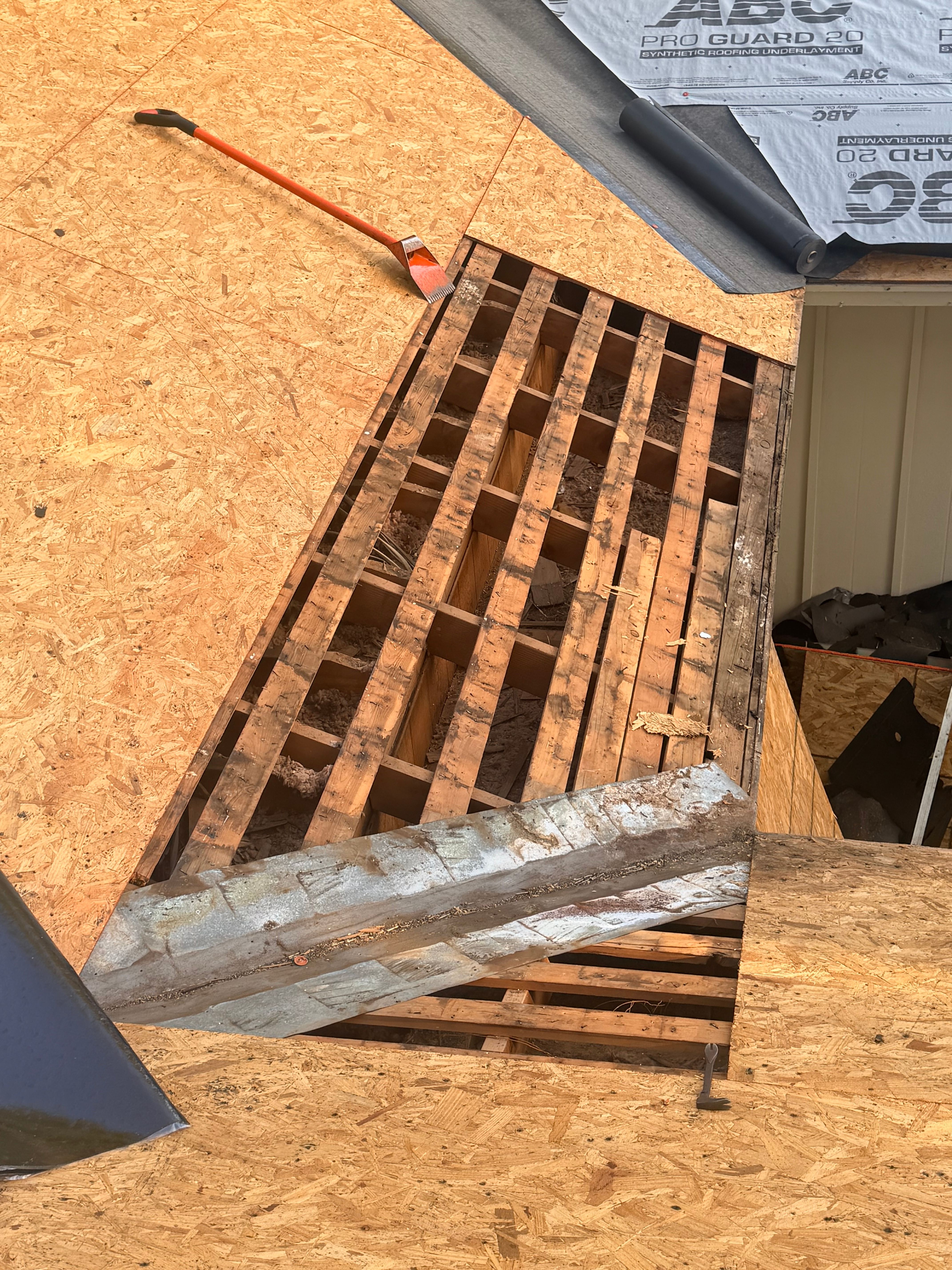 Close-up of exposed roof rafters during old decking removal