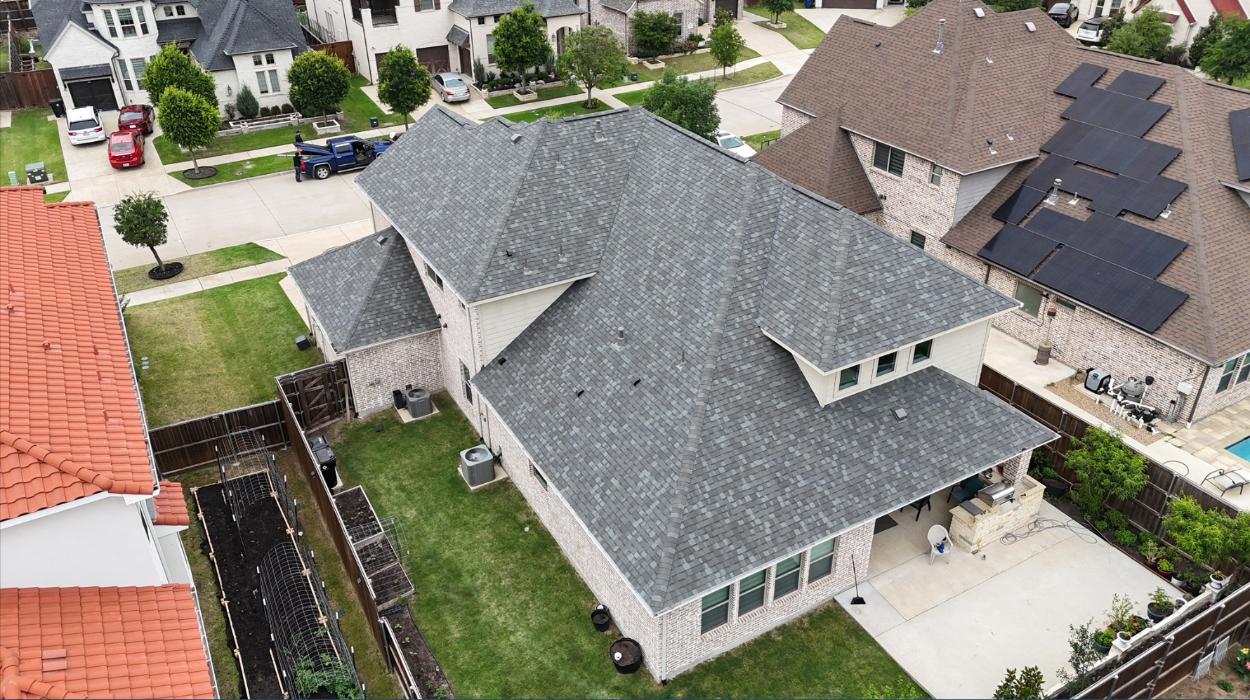 Aerial backyard view of completed gray shingle roof