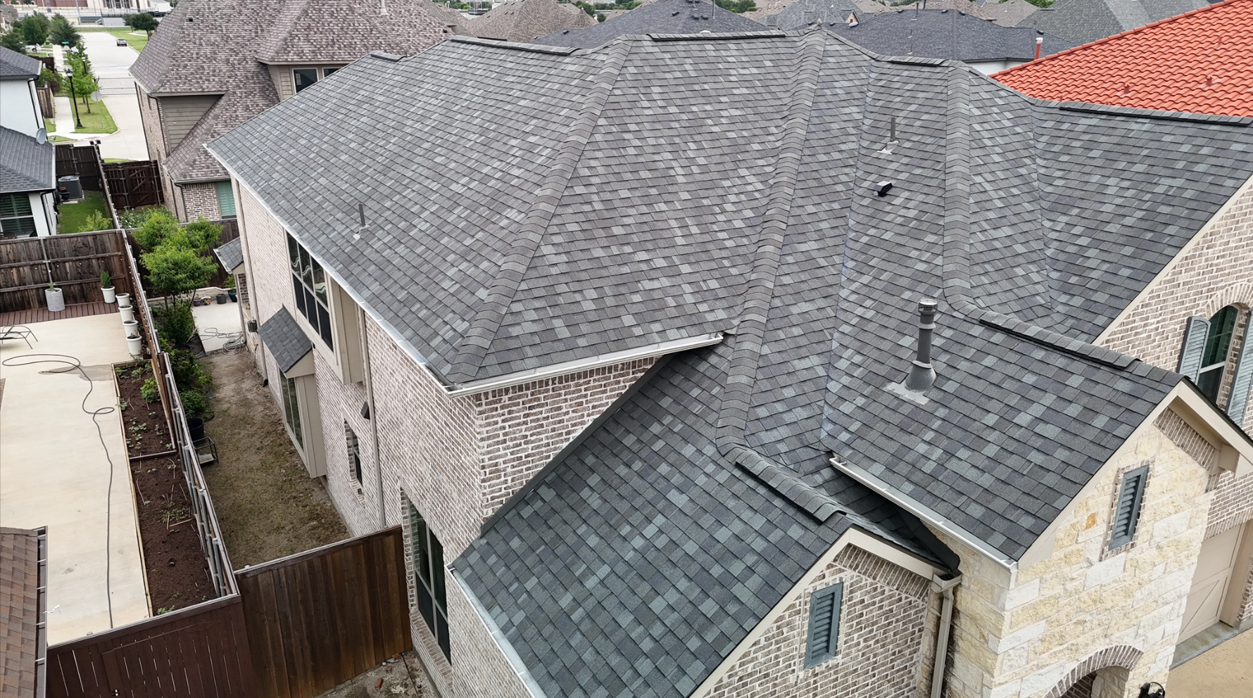 Aerial view of completed complex roof with multiple peaks and valleys