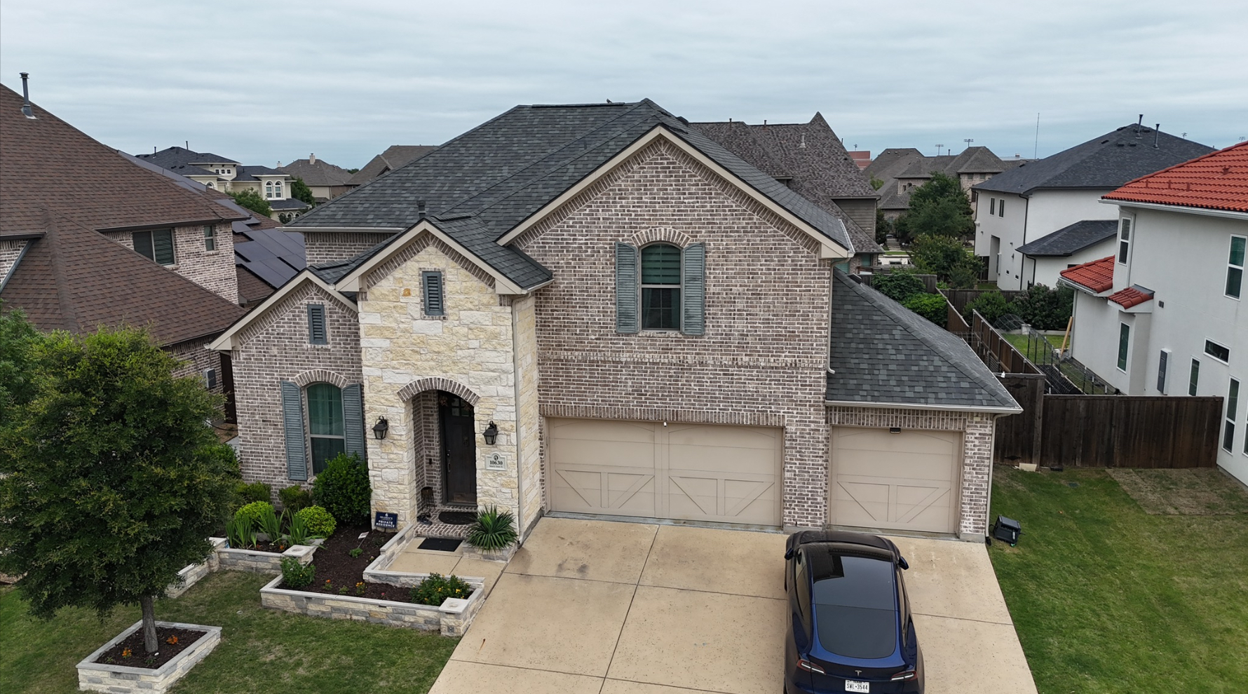 Completed roof replacement - front view of beautiful Texas home