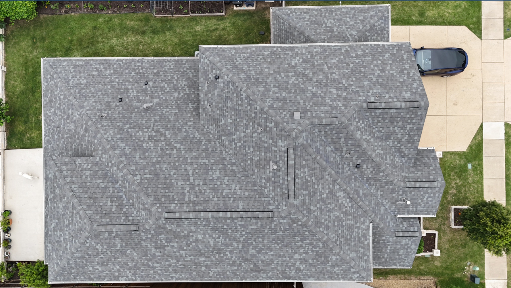 Top-down aerial view of completed gray shingle roof