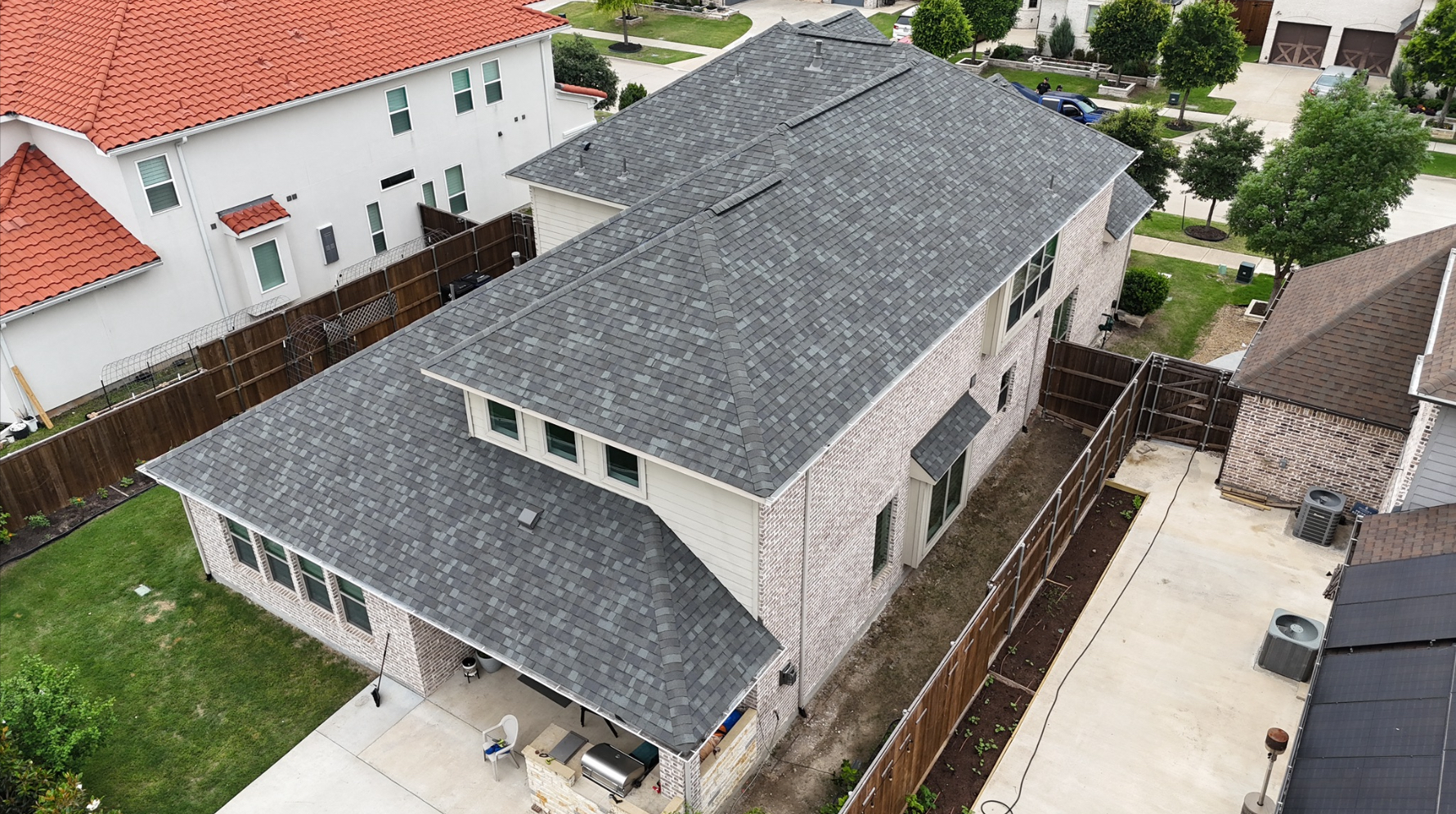 Aerial view of completed two-story home with new roof