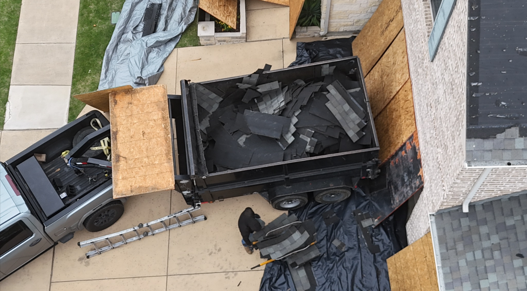 Dump trailer with old roofing debris for clean removal