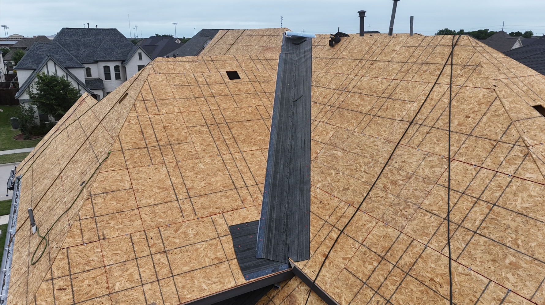 New OSB decking with valley flashing installed