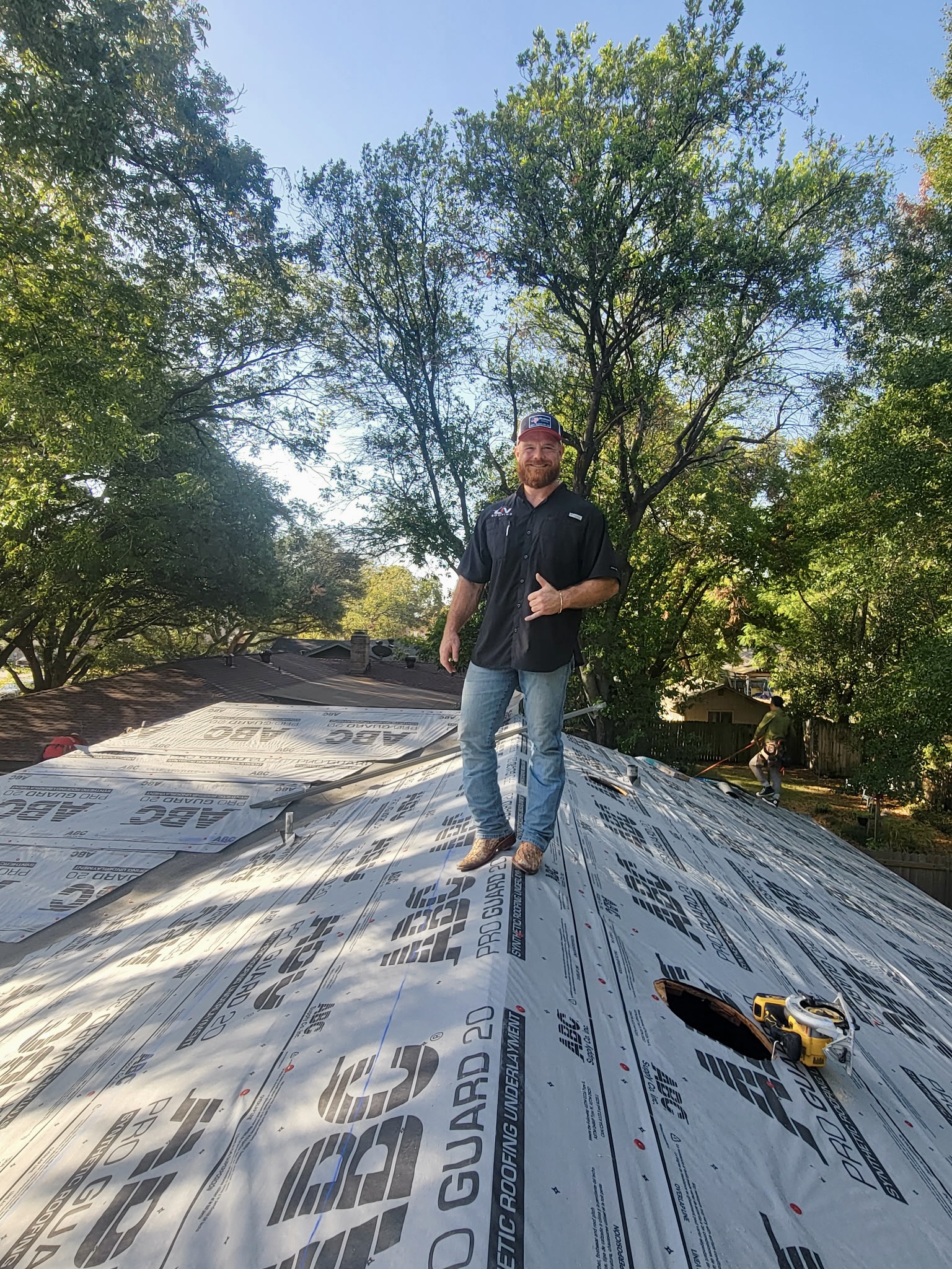 LIV Construction team member on a roof covered in ABC Pro Guard synthetic underlayment