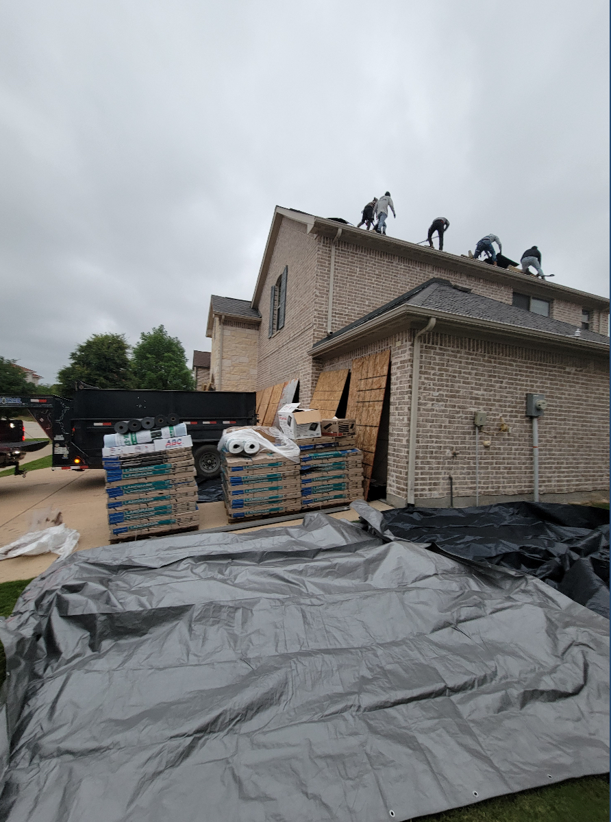Roofing crew working on residential home