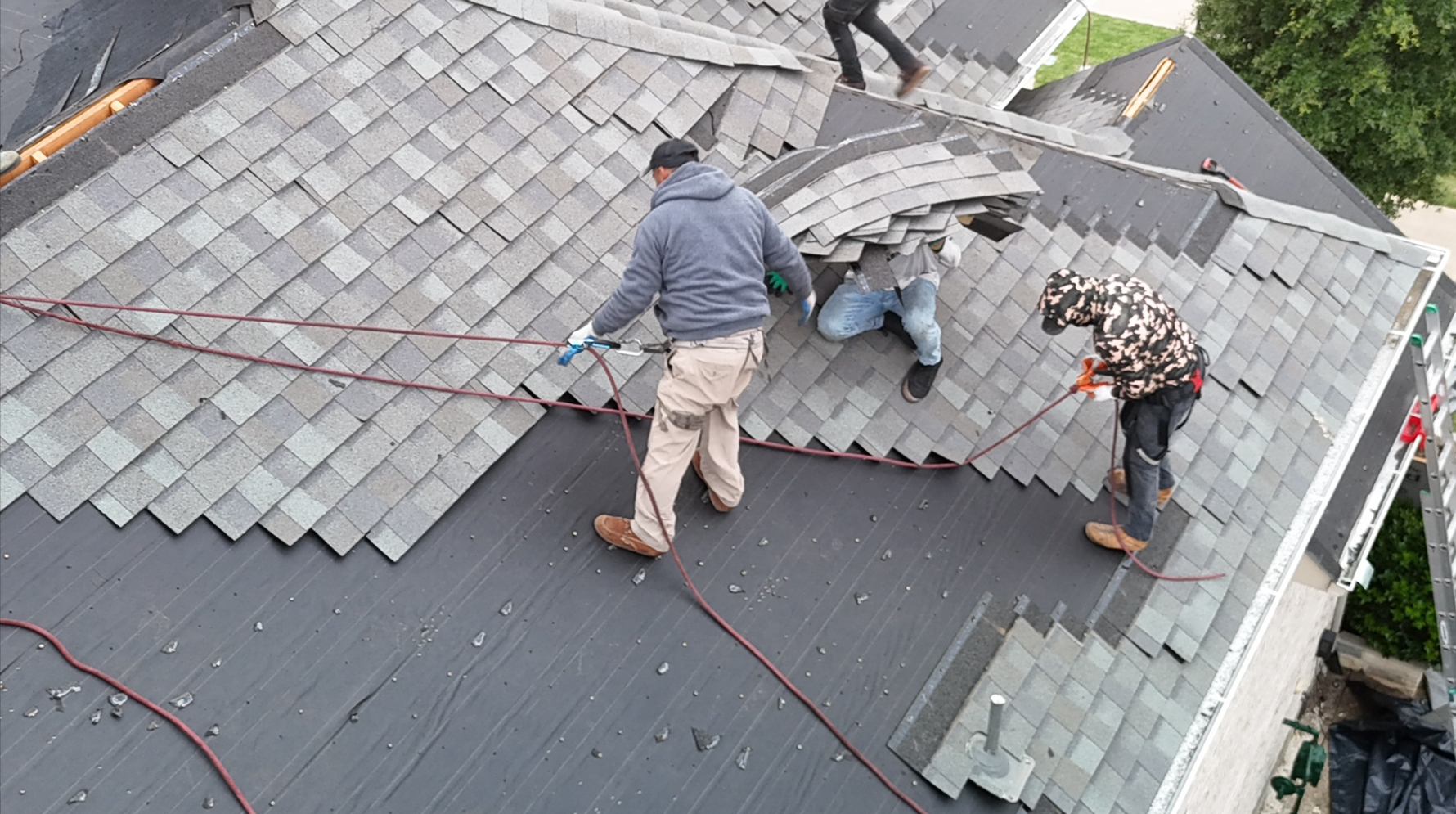 Close-up of roofers installing new shingles