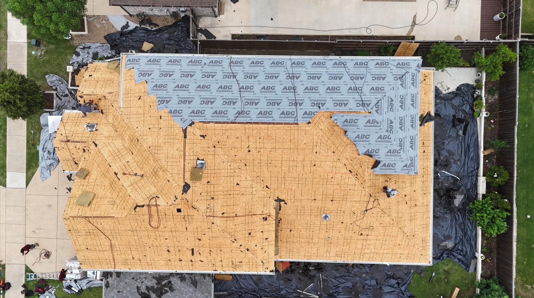 Aerial view showing underlayment installation progress on roof decking